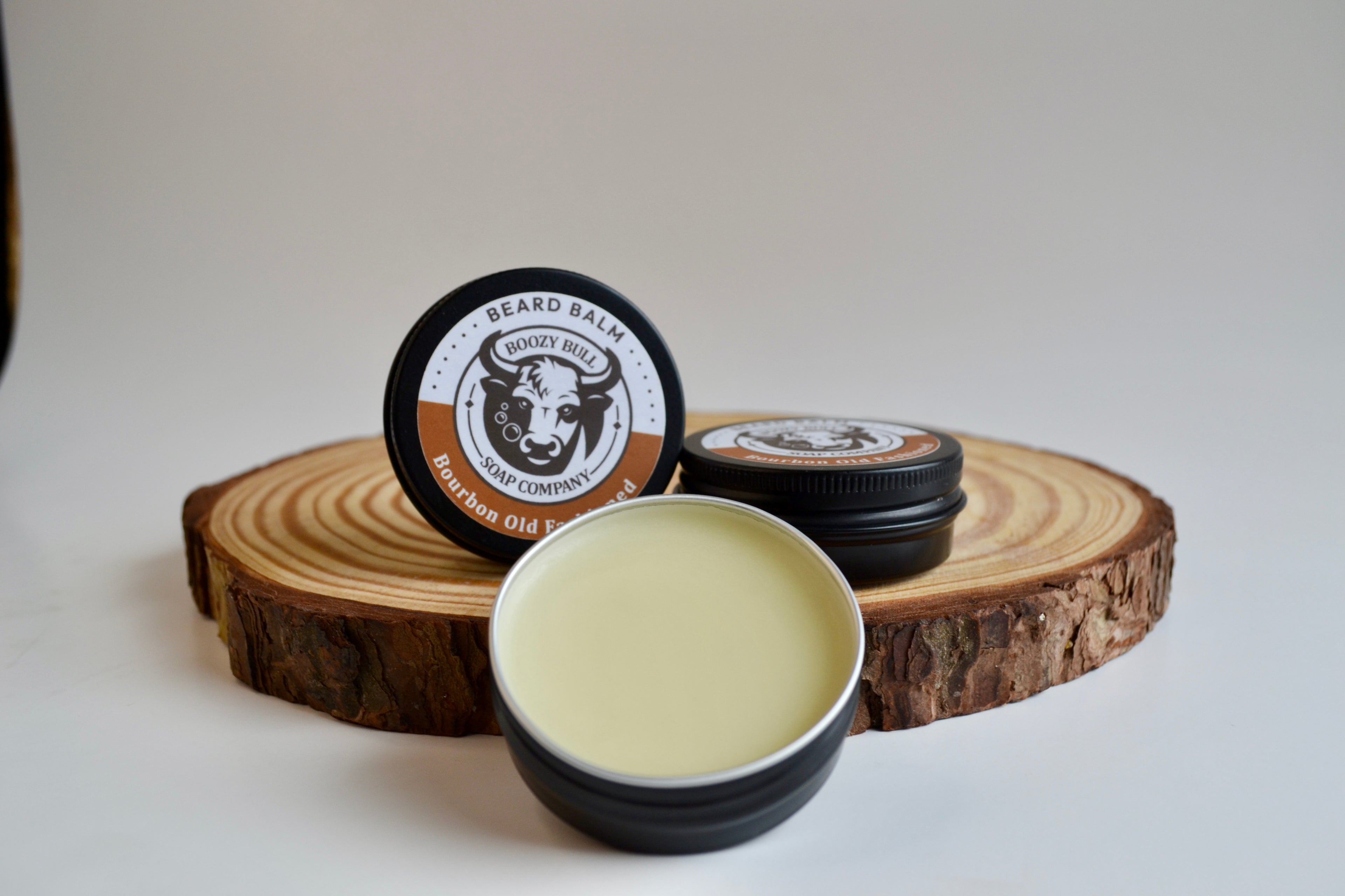 Beard balm container with wooden lid on a white background