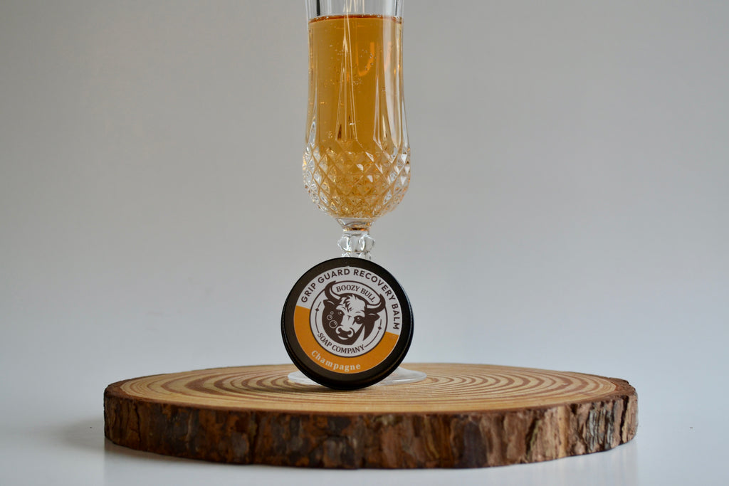 Glass of beer with a wooden coaster featuring a brand logo on a neutral background