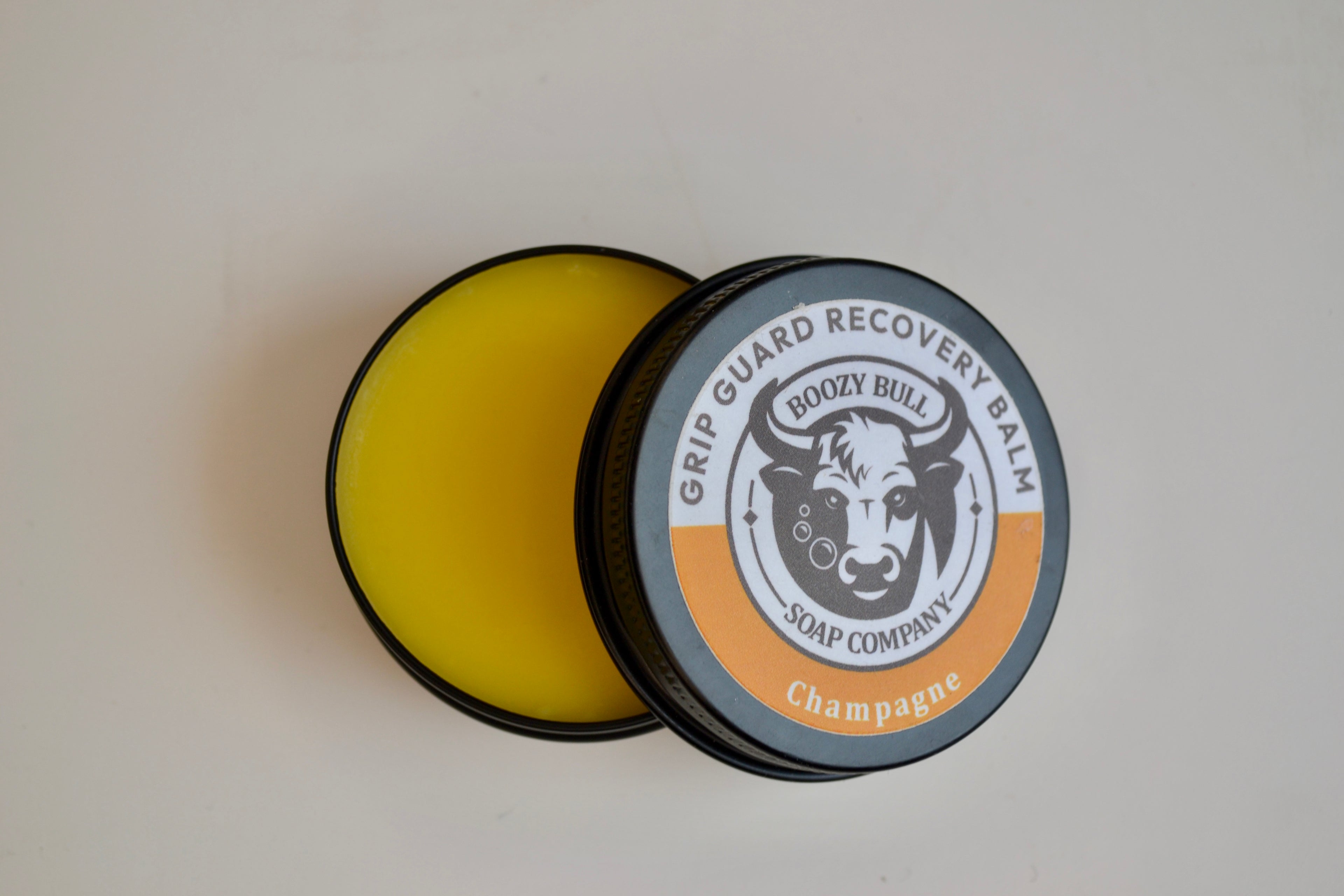 Grip Guard Recovery Balm container with 'Boozy Bull Soap Company' branding on a light gray background