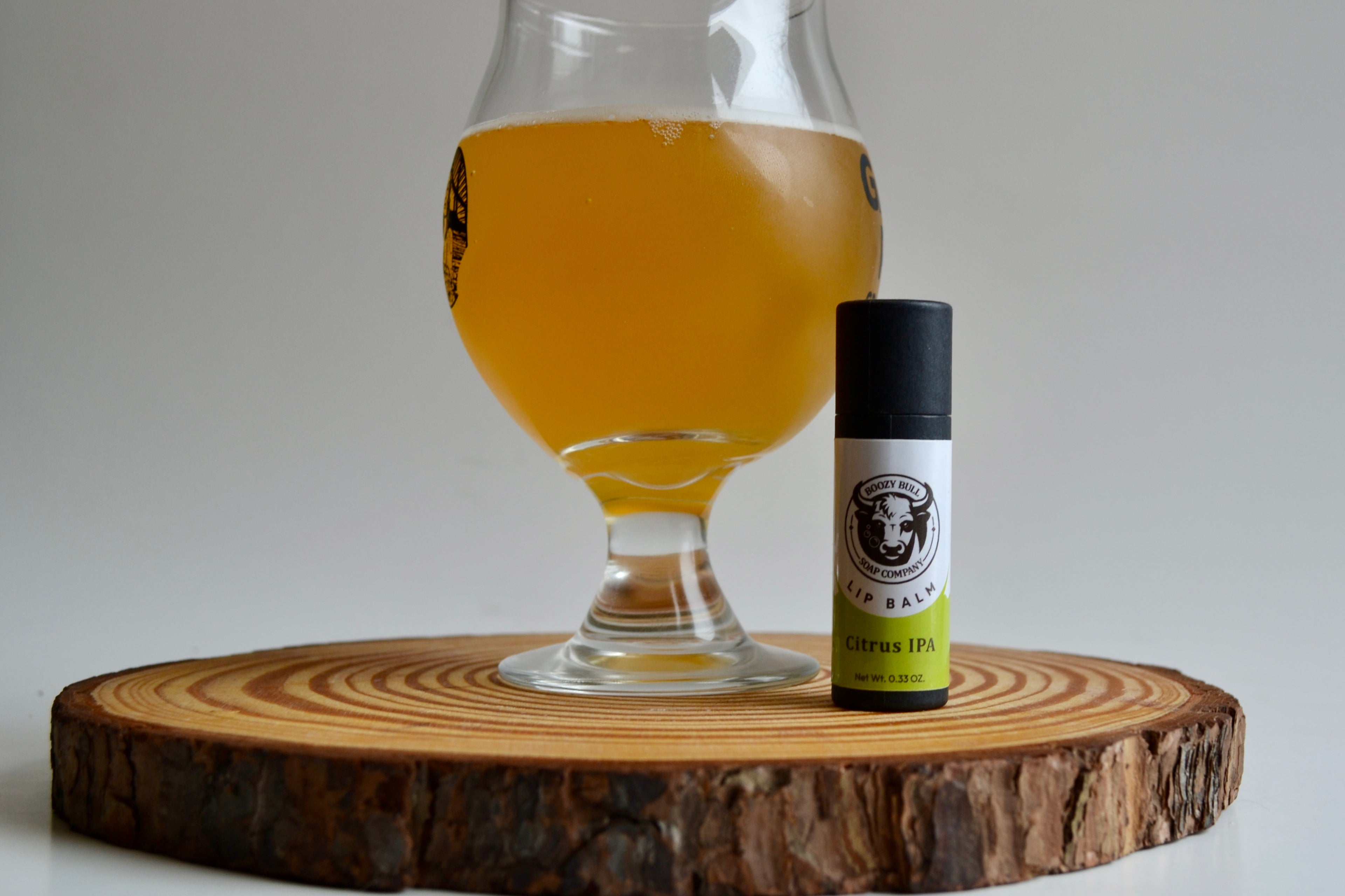 Glass of beer and a bottle on a wooden board with a white background
