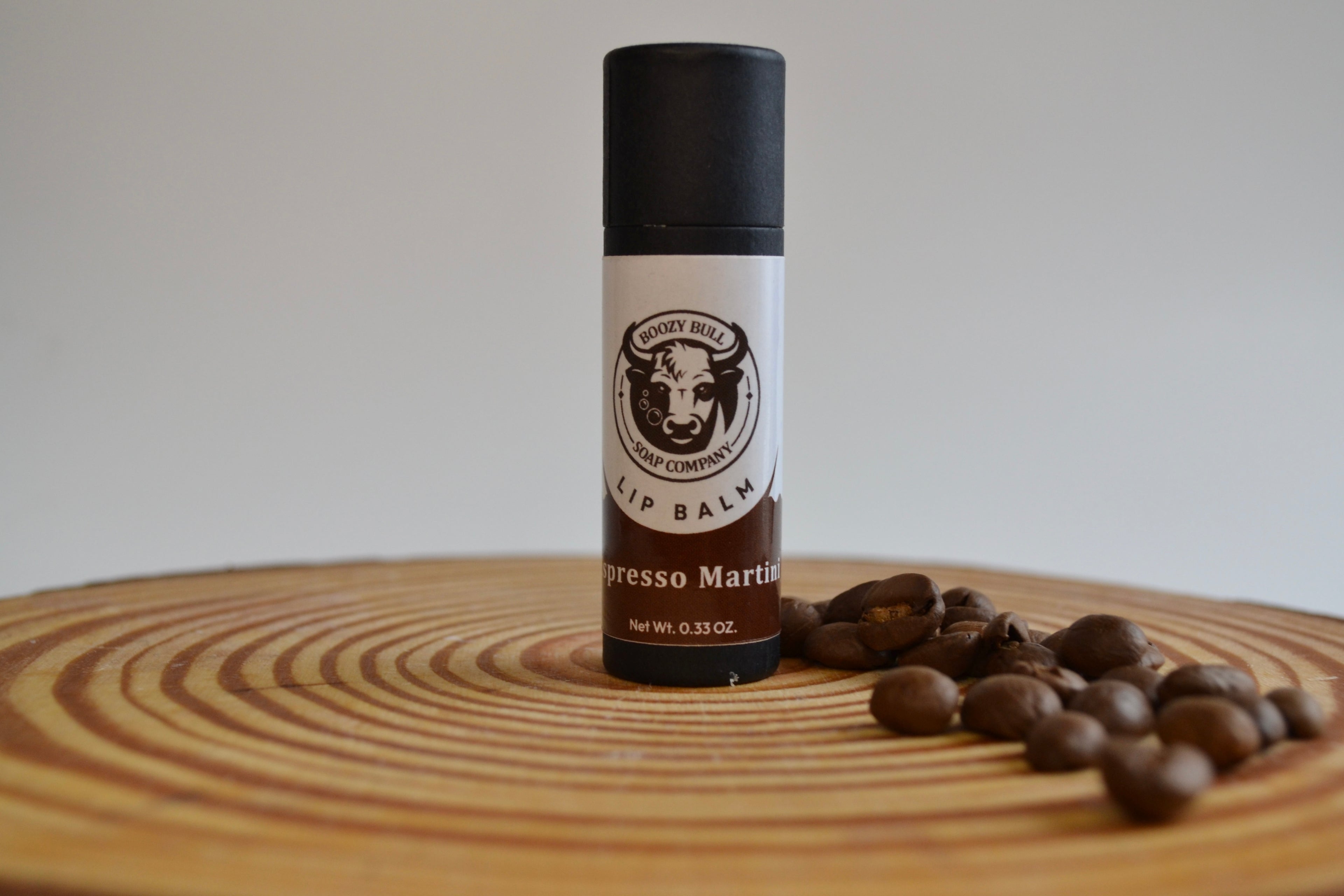 Lip balm with coffee beans on a wooden surface