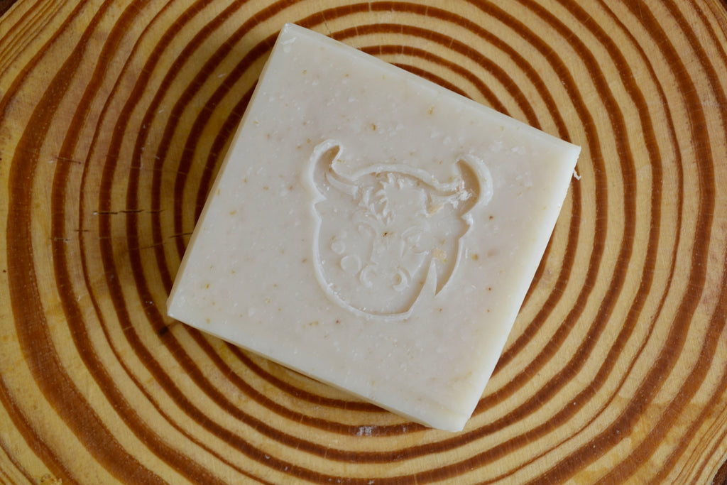 Bar of soap with a bull logo on a wooden surface