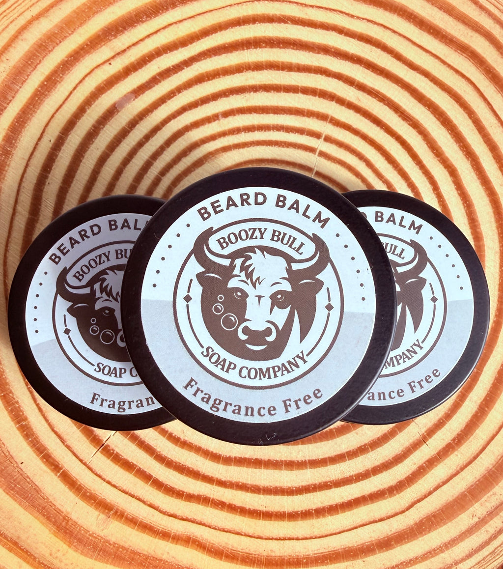 Three containers of Beard Balm from Boozy Bull Soap Company on a wooden background
