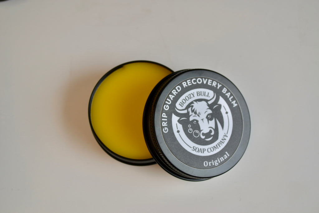 Grip Guard Recovery Balm container with yellow balm inside on a white background