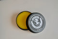 Grip Guard Recovery Balm container with yellow balm inside on a white background