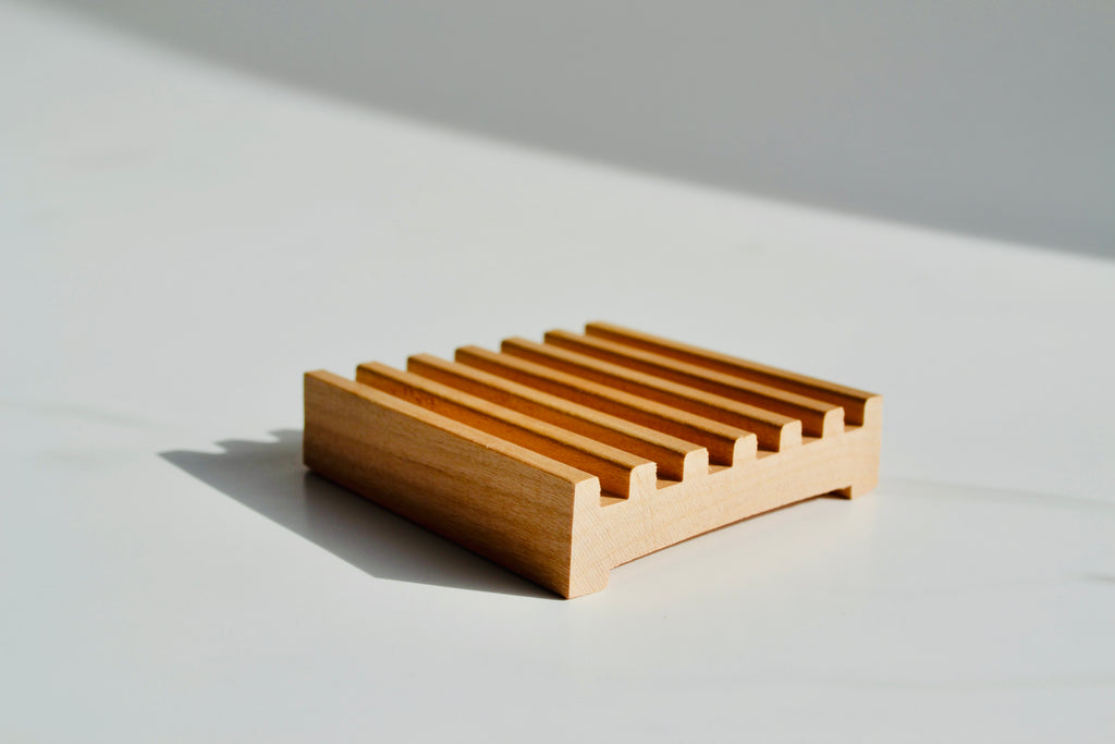 Wooden soap dish on a light gray background